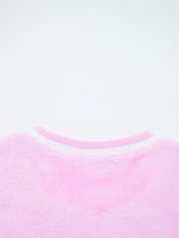 Pink fuzzy sequin chenille merry graphic plush sweatshirt with ribbed white collar and slightly stretchy fabric