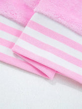 Pink and white striped slightly stretchy knit fabric with soft fuzzy texture in sequin chenille merry graphic plush sweatshirt