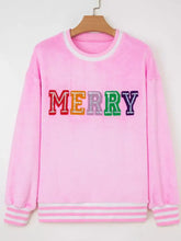 Pink slightly stretchy sequin chenille merry graphic plush sweatshirt with rainbow lettering and white striped cuffs