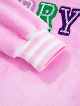 Pink plush sequin chenille merry graphic sweatshirt with colorful sequined lettering and striped slightly stretchy cuffs