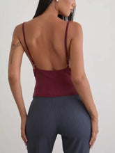 A maroon backless fitted crop top with thin straps featuring sequin detail ruched tank design without cowl neck