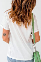 Woman in sequin flower round neck short sleeve T-shirt with jeans and bag