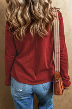 Woman in sequin heart long sleeve V-neck T-shirt with jeans and bag