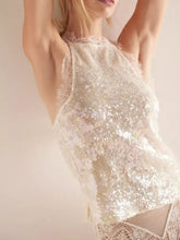 A shimmering white sequin lace trim halter neck cami featuring delicate lace trim on a halter neck design