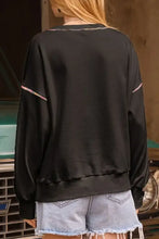 Sequin pumpkin round neck long sleeve sweatshirt with black base and colorful striped shoulder piping