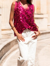 A vibrant fuchsia sequin round neck tank with sleeveless design sheer neckline and frayed hem
