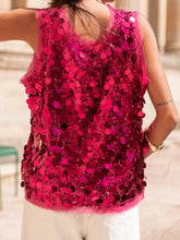 A vibrant fuchsia sequin round neck tank with sleeveless design sheer mesh backing and ruffled hem detail