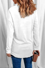 White long-sleeve oversized tunic top with curved hem