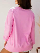 A soft pink sequin xoxo letter graphic baggy sweatshirt with slightly stretchy fabric and frayed hem care instructions included