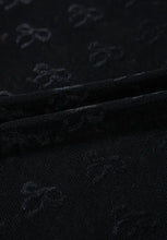 Sheer black mesh top with bow pattern and subtle sheen