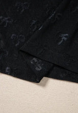 Sheer black mesh top with bow pattern and black skull scarf