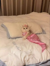 Fluffy white cat in shiny mermaid pet costume with glittery scales and bow