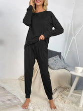 Black shiny round neck top and drawstring pants lounge set with elastic cuffs designed for comfortable loungewear