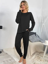 Black shiny round neck long-sleeved top and drawstring pants lounge set with relaxed fit and comfortable waistband