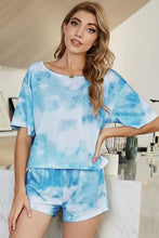 Blue and white tie-dye shiny two-piece loungewear set with boat neck and short sleeve length top and matching shorts