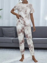A soft tie-dye pajama set with round neck top and short sleeve length in muted white and dusty rose hues