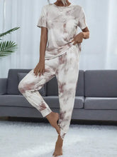 A shiny tie-dye round neck short sleeve top and pants lounge set in beige and dusty rose cotton blend fabric