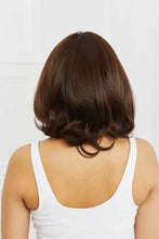 Woman in short wavy dark brown bob synthetic wig with bangs, cap included