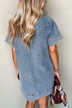 A light blue denim mini dress with short sleeves, collared neck, and patched pocket in a relaxed fit