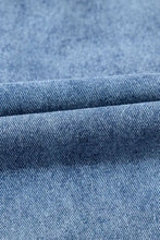 Short sleeve collared patched pocket denim mini dress in medium-wash blue denim with classic twill weave and subtle fading