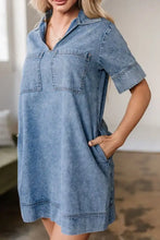 Denim mini dress with short sleeves, collar, and two front patched pockets in blue denim fabric