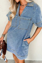 A light blue denim mini dress with short sleeves, collar, and front patched pockets in denim material