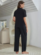 Black short sleeve length pajama set with collared top and wide-leg pants for comfortable loungewear