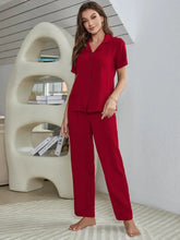 Red short sleeve length button-up pajama top with matching wide-leg pants in comfortable lounge set material