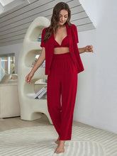 Red two-piece loungewear set with cropped blazer featuring button details and high-waisted pants with short sleeve length