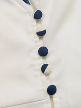 White blouse with navy blue and white half-moon buttons, Short Sleeve Top and Skirt Set