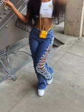 A bright yellow mini handbag with a handle worn crossbody paired with side distressed jeans for casual wear