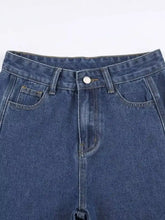 Blue denim high-waisted distressed jeans with classic button closure and front pockets for casual wear
