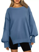 Blue oversized sweatshirt with ribbed cuffs hem relaxed fit and asymmetrical side slits tumble dry low care instructions