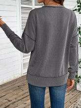 Side slit round neck sweatshirt in cozy gray and black stripes with slightly stretchy fabric and machine wash cold care instructions