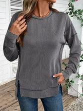 Side slit round neck sweatshirt featuring gray and white vertical stripes with a relaxed fit and slightly stretchy fabric, machine wash cold care instructions