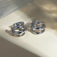 Shiny silver spiral hoop earrings in layered cuff set