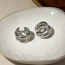 Two silver-toned spiral ear cuffs in layered cuff earrings set