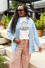 Woman in Simply Love round neck short sleeve t-shirt with denim shirt and cheetah pants