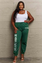 Plus-size woman in Simply Love sun graphic sweatpants