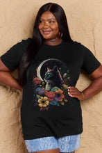 Full size cat graphic cotton tee: black round neck t-shirt with colorful cat, moon, flowers, paired with denim shorts