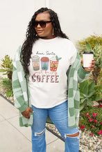 Woman in Simply Love coffee graphic short sleeve t-shirt, cardigan, jeans, holding coffee