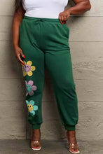 Simply Love full size drawstring green sweatpants with smiley flowers