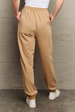 Light brown Simply Love emoji graphic sweatpants with elastic waist and cuffed ankles