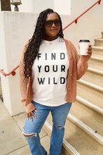 Woman in Simply Love wild short sleeve t-shirt with cardigan and jeans