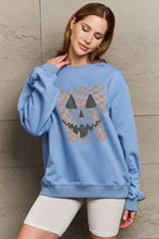 Light blue long-sleeved graphic dropped shoulder sweatshirt with jack-o-lantern