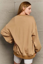 Woman in Simply Love Halloween element graphic sweatshirt with long sleeves