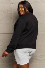 Plus-size black long-sleeved Halloween graphic sweatshirt with white biker shorts