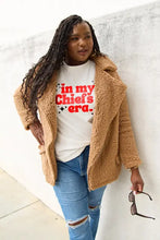 Woman in tan teddy bear coat and ripped jeans wearing Simply Love Chiefs Era short sleeve T-shirt