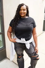 Simply Love Full Size KILLIN’IT Short Sleeve T-Shirt with ripped black jeans and plaid shirt tied around waist