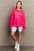 Hot pink oversized round neck sweatshirt with full size letter graphic